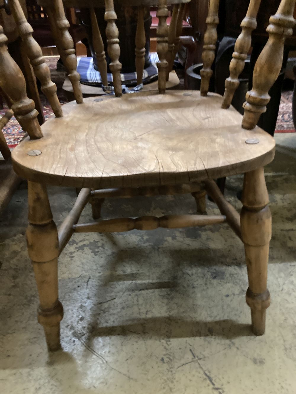 Two Victorian elm and beech smokers bow elbow chairs together with six Windsor kitchen chairs